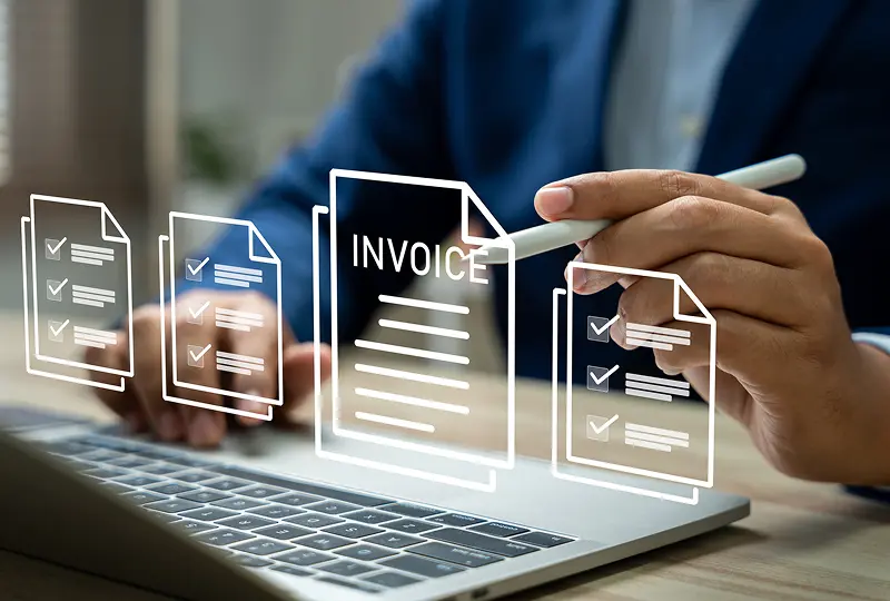 Person reviewing digital invoices on laptop.